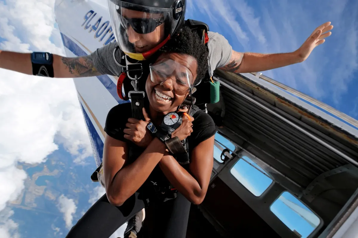 A tandem skydive in freefall against open sky